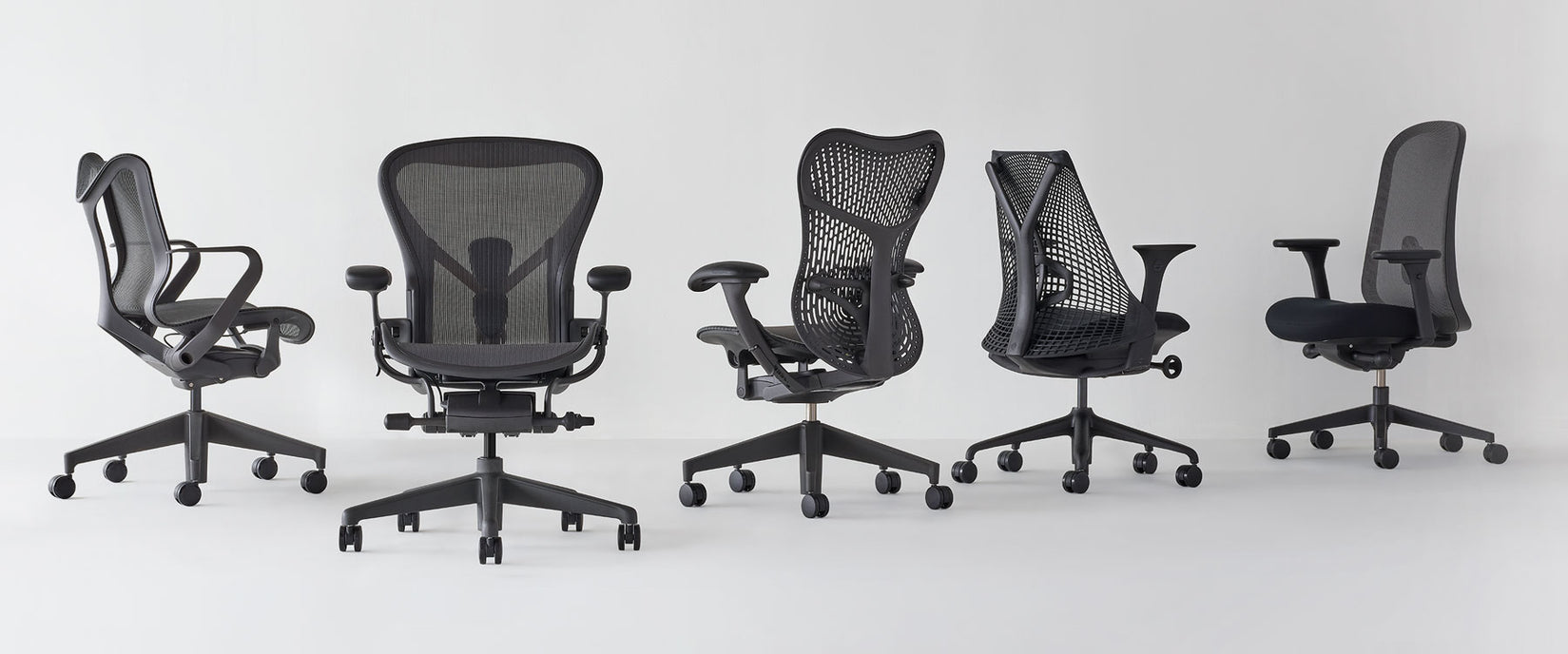 Line up of Herman miller home office chairs at different angles all in graphite featuring Cosm low back, Aeron , Mirra 2 and Lino