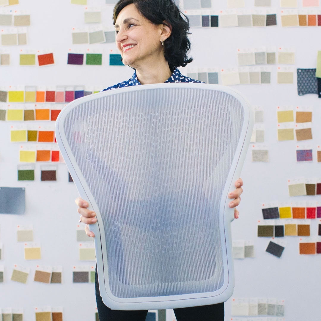 Video showing Herman Miller colleague holding different coloured back support component of the Aeron Office chair