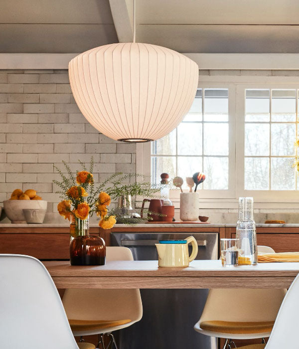 A Nelson apple Bubble lamp shade providing warm light to a modern farmhouse kitchen.