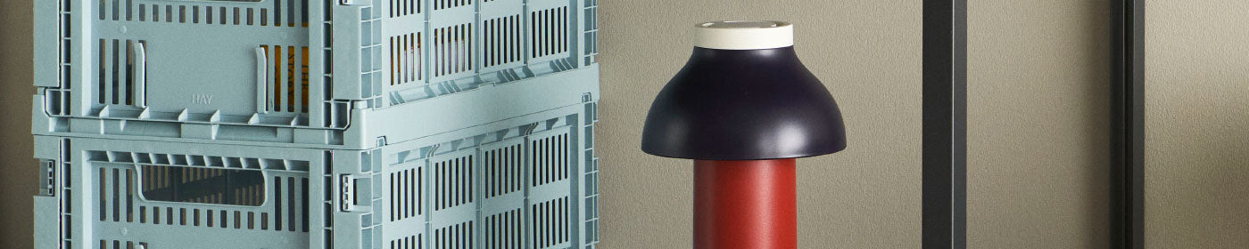A pair of pale blue storage crates and a portable lamp.