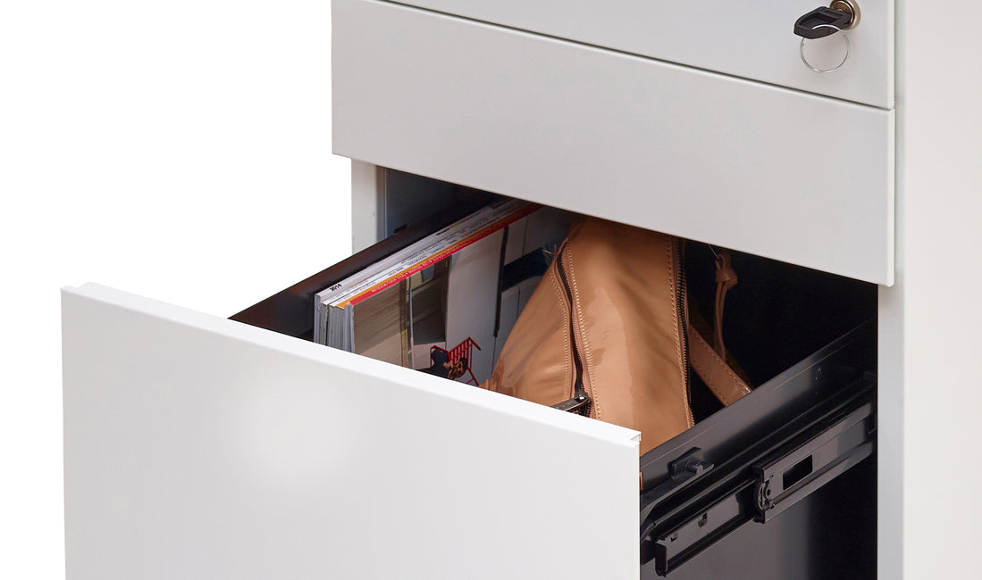 A close view of the open drawer of a Kumi Pedestal office storage system.