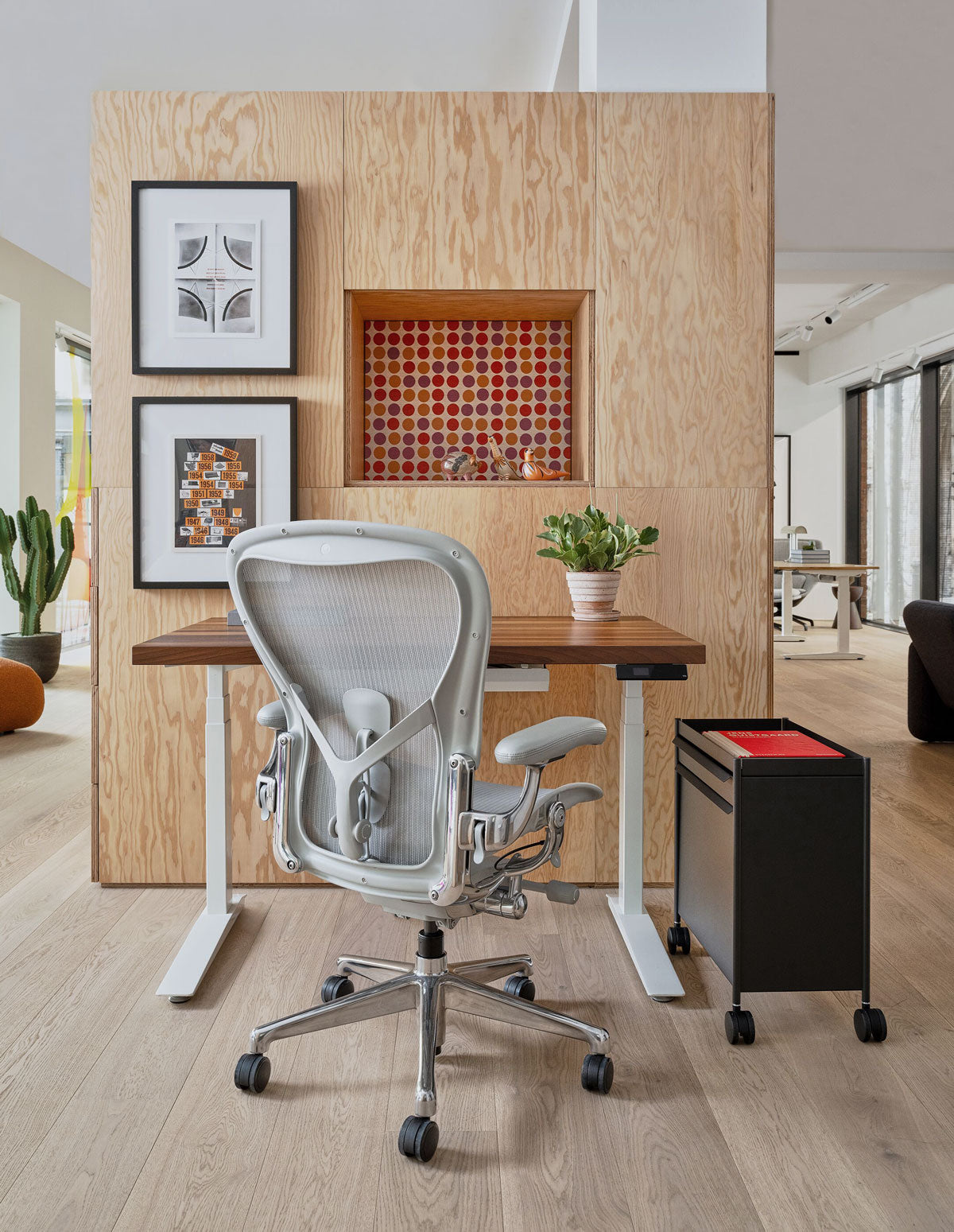 A Herman Miller Aeron in polished mineral grey, with a solid wood topped Jarvis sit stand desk in our London showroom.