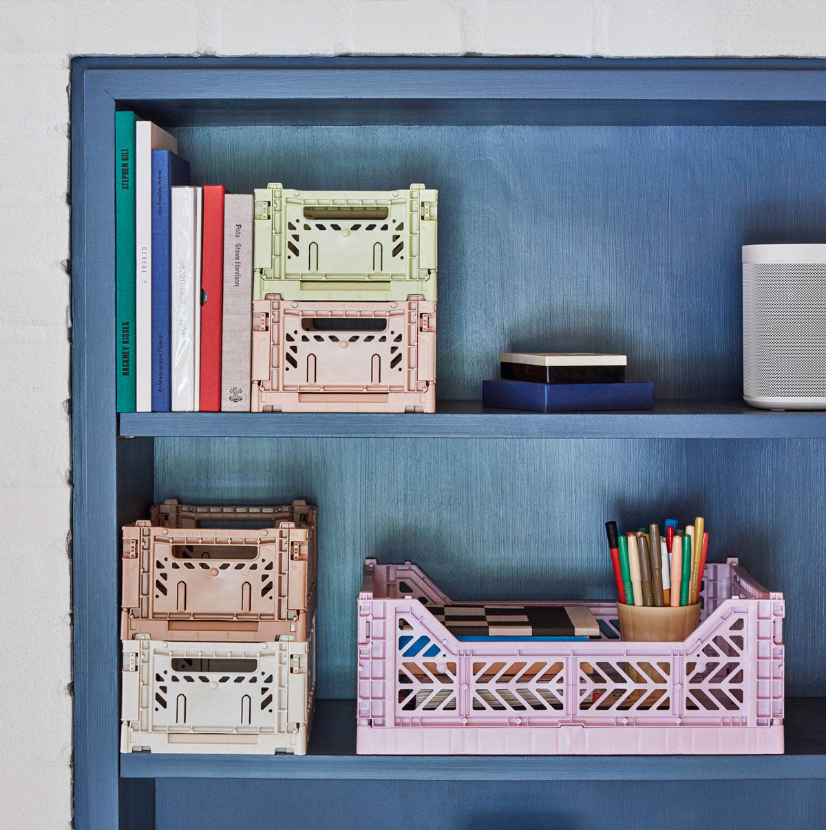 Home shelving showing Hay Storage crates in various sizes with some books