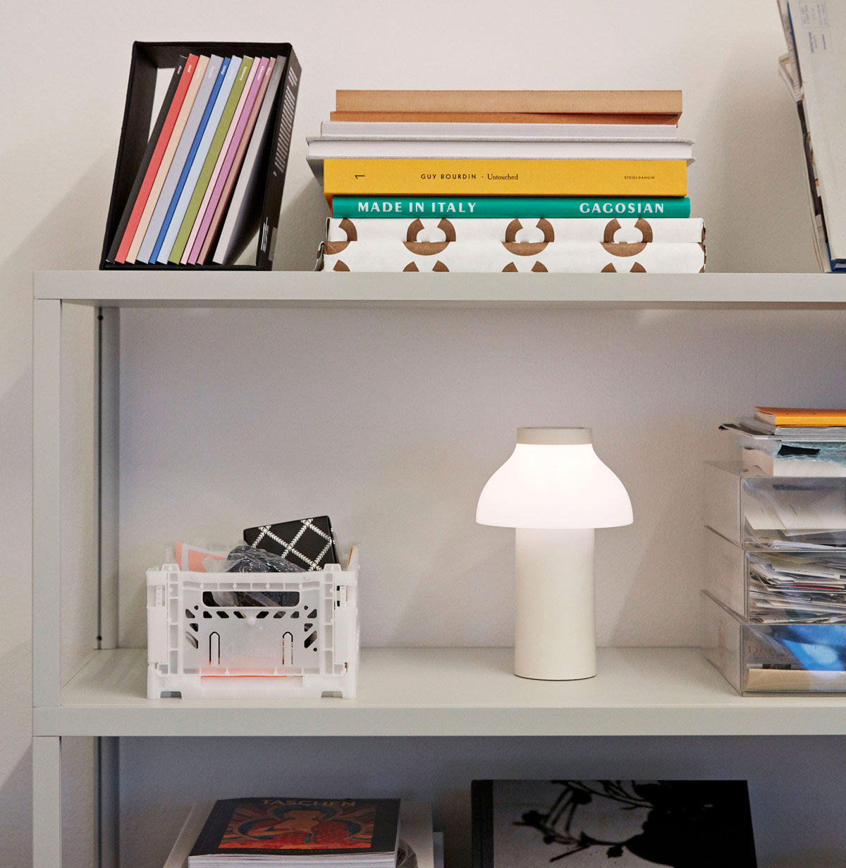 Home shelving with a Hay PC portable lamp in cool grey