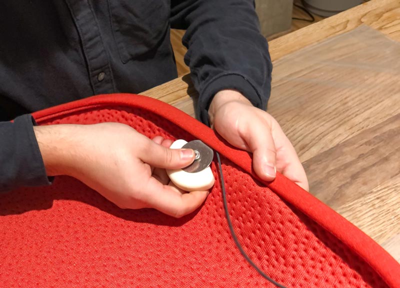 Photo of the 3D knit seat cover for Zeph office chair being finished in blaze red