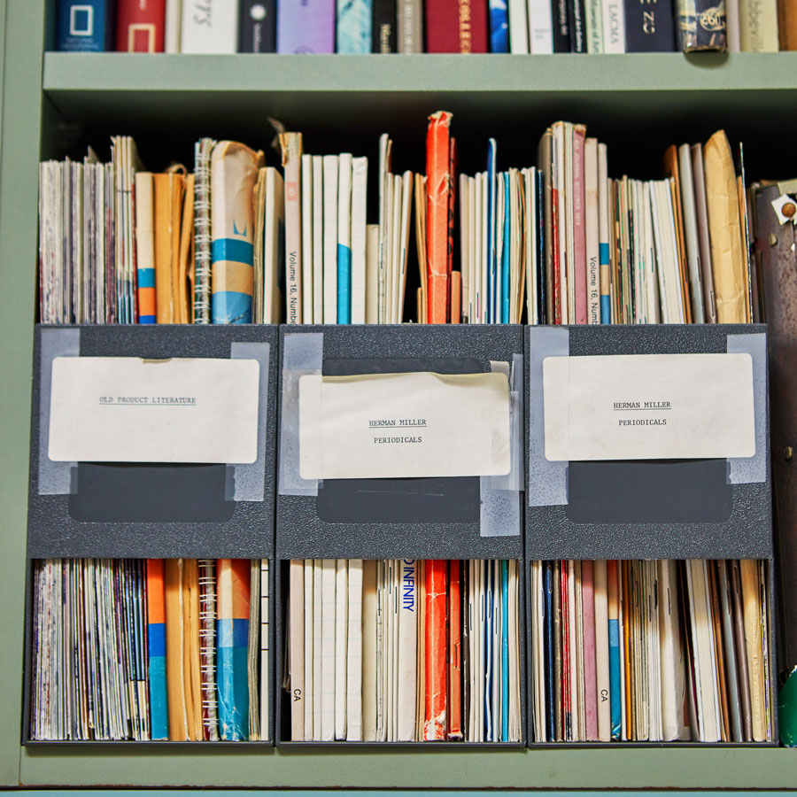 Image of shelf with design & research files that all relate to Herman Miller product design and development