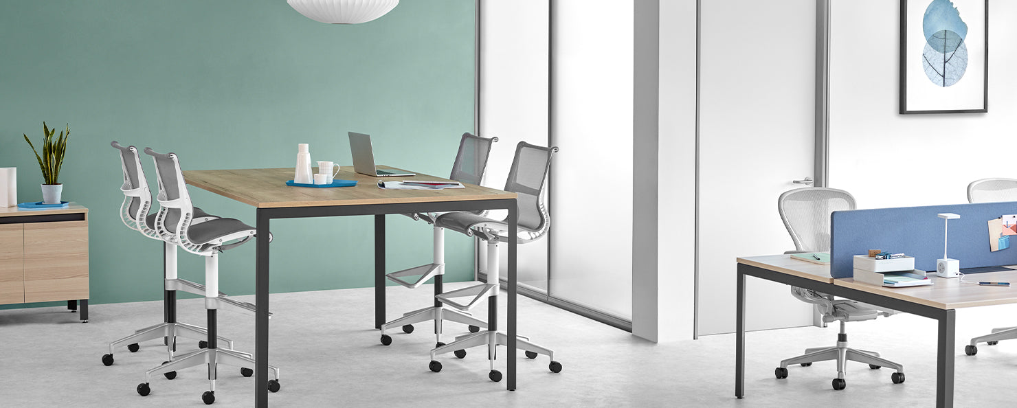 Four grey Setu stools in a casual meeting environment